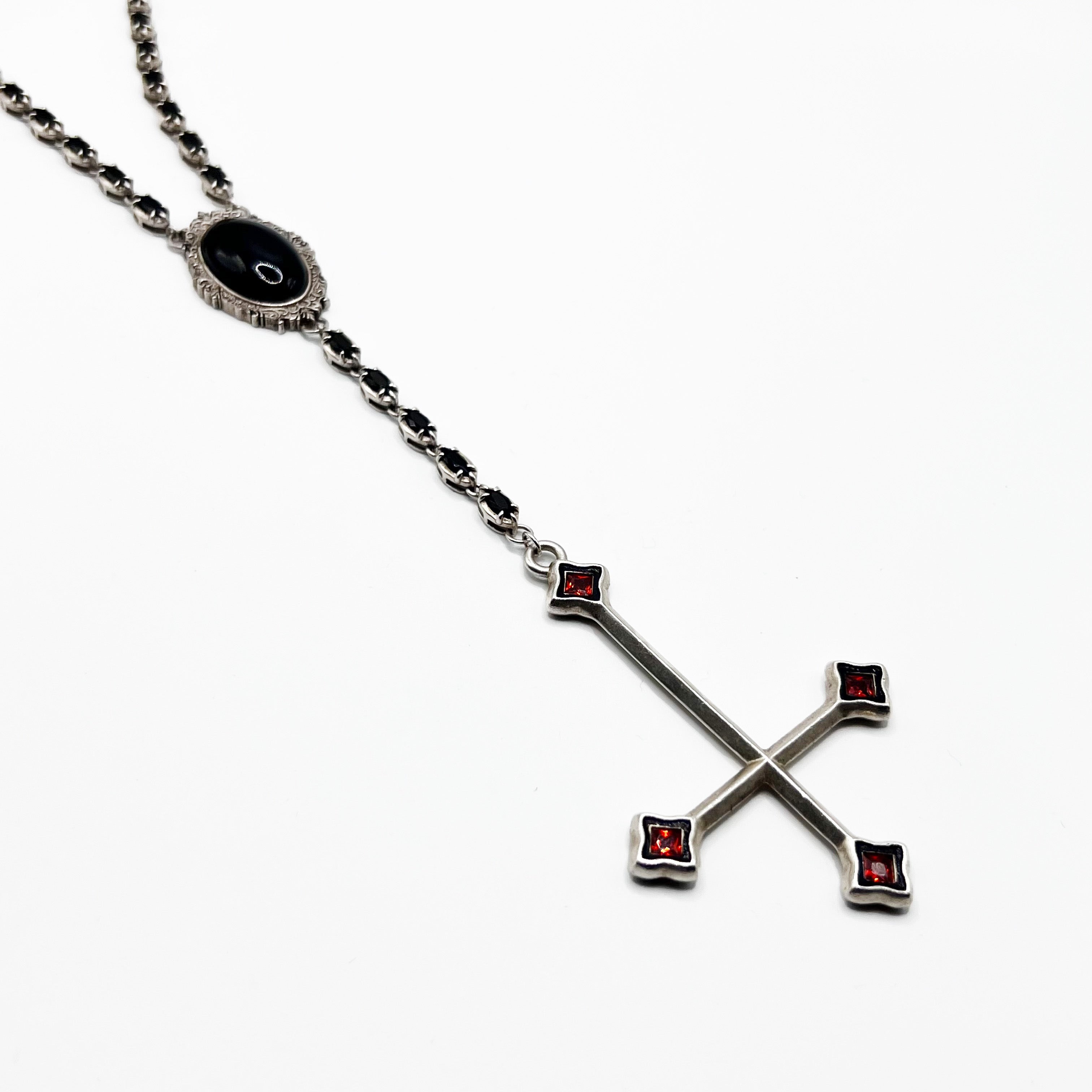 Alucard’s Rosary -A necklace with a cross and red stones.