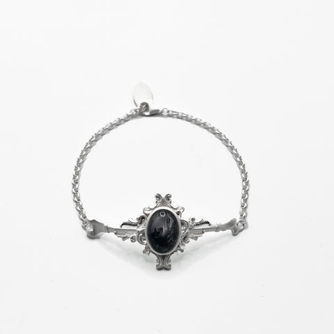 silver bracelet with a black Moonstone on it.