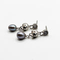 A pair of Silver Skull Head  earrings with black pearls