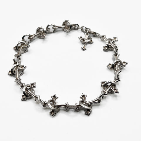 Sanctuary Chain  bracelet with a cross on it.